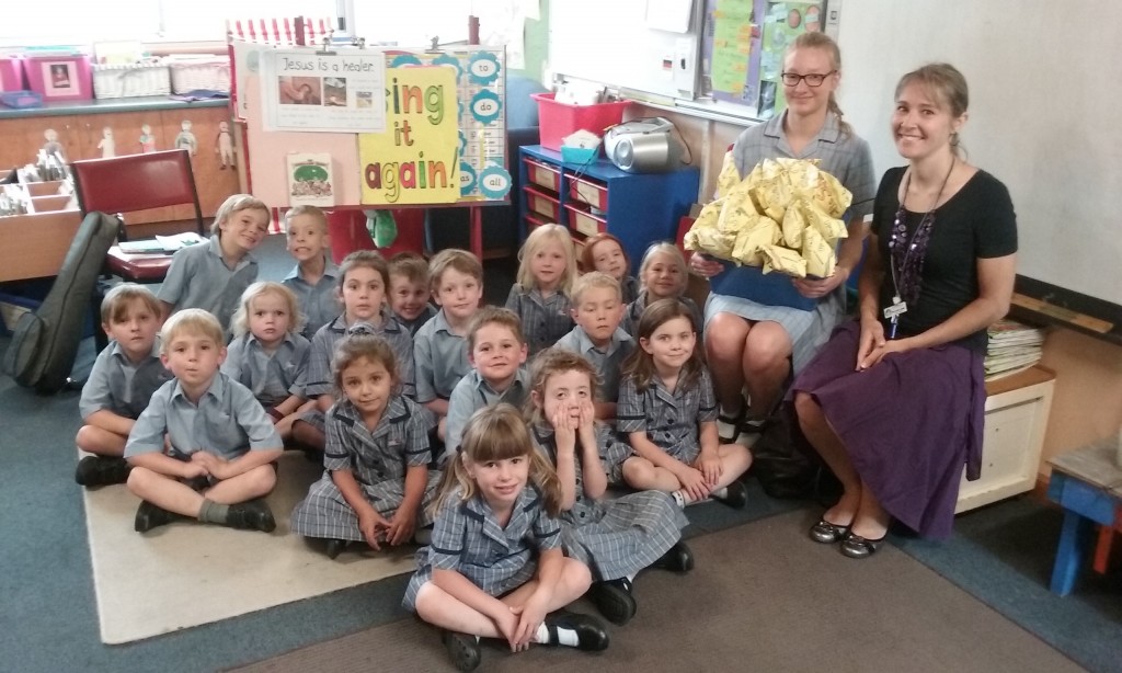 FJS ready to be presented with their ,,Schultüten'' by Sina Krause, a visiting Yr 11 Cornerstone student from Germany, and Frau Janine Liebelt, a St Michael's parent and staff member who generously helps us with the ,,Schultüten'' each year, those special treats given to students in Germany on their first day of school.